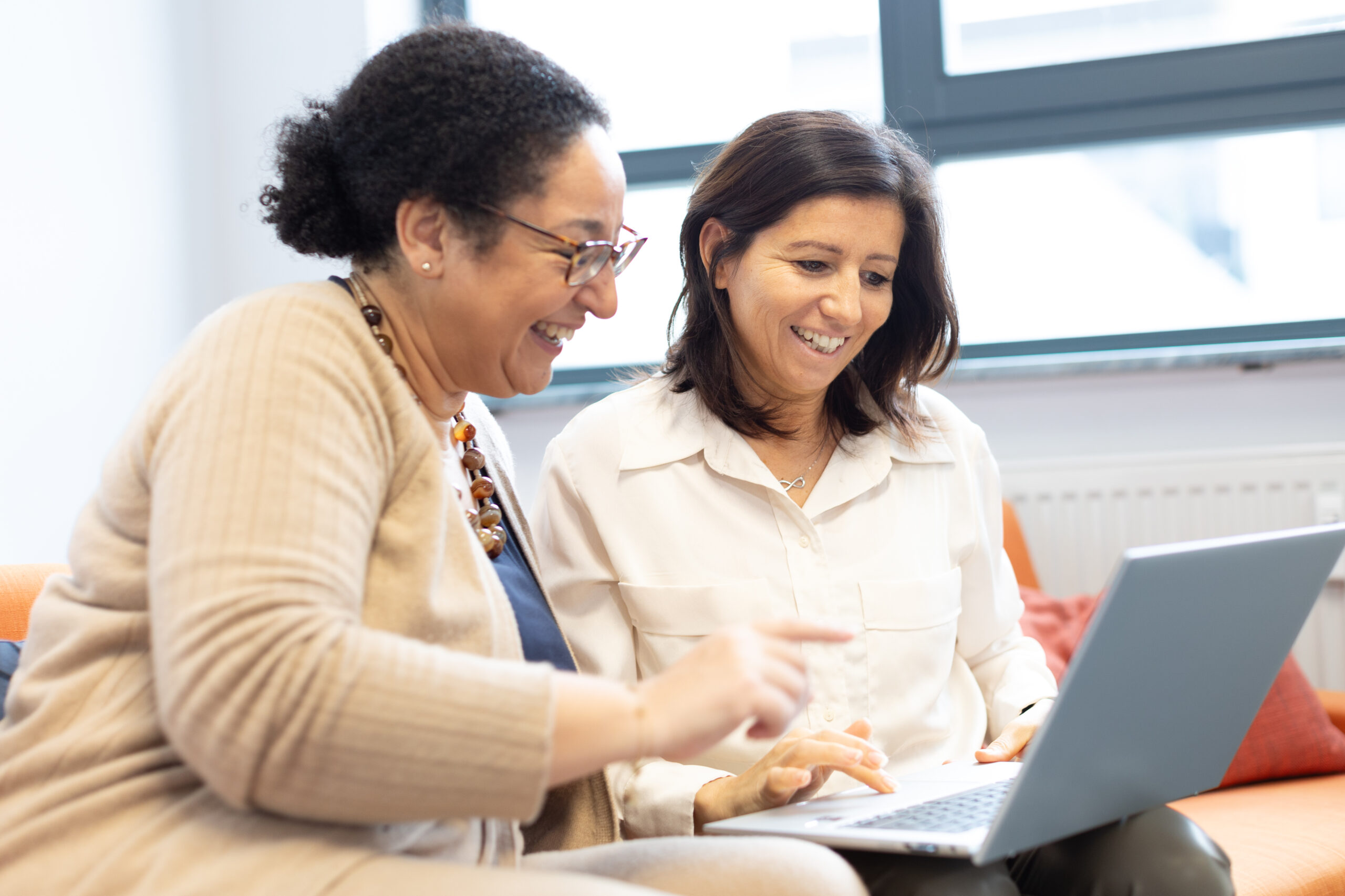 Two ERNI female employees discussing software quality and regulatory compliance in a modern work environment